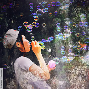 The girl and the colored soap bubbles